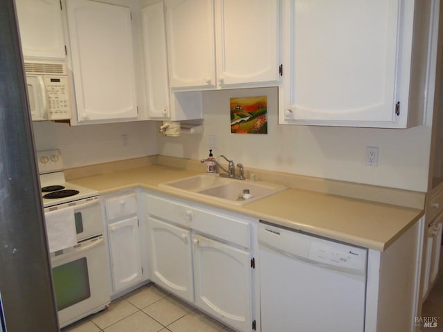 kitchen with sink, white cabinets, and white appliances