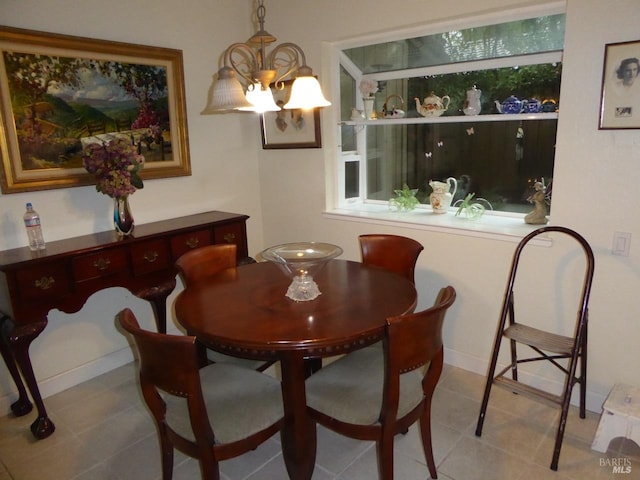 tiled dining area with a notable chandelier