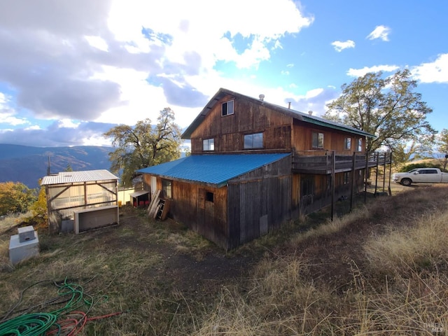 view of property exterior with a mountain view