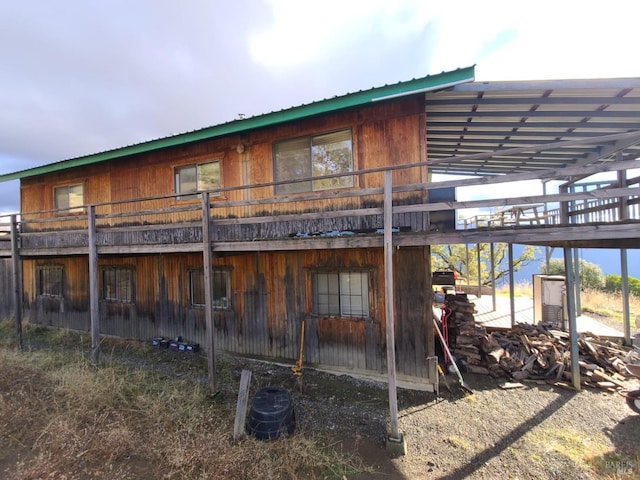 back of house with a deck