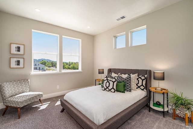 carpeted bedroom featuring recessed lighting, visible vents, and baseboards