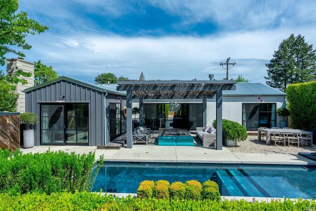 rear view of house featuring an outdoor structure, a patio area, and a pergola