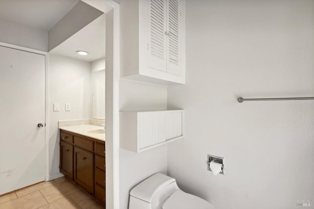 bathroom featuring tile patterned flooring, vanity, and toilet