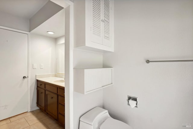 bathroom featuring toilet, tile patterned floors, and vanity