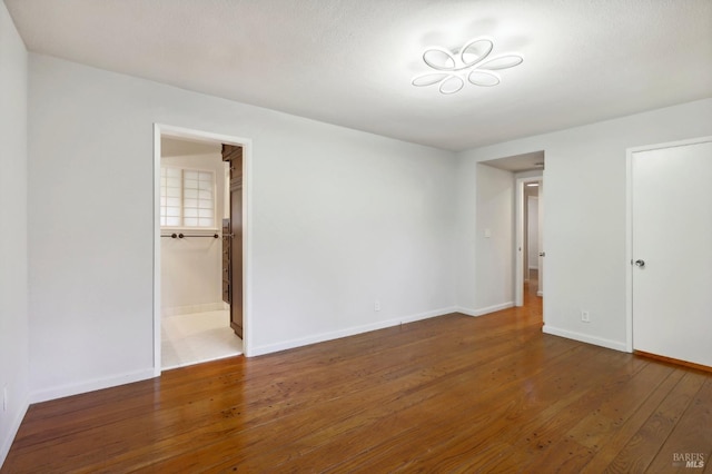 unfurnished room featuring dark hardwood / wood-style floors