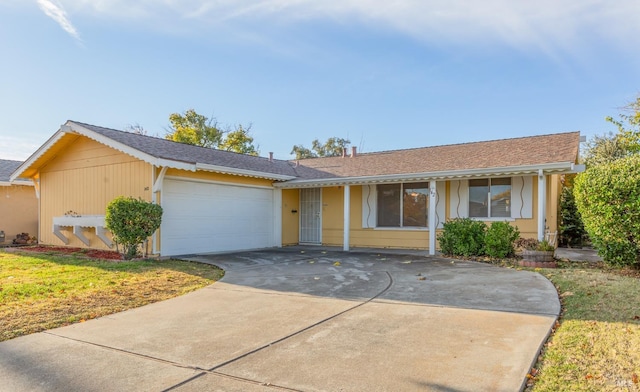 ranch-style home with a garage and a front yard