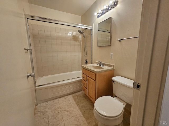 full bathroom featuring tiled shower / bath, vanity, and toilet