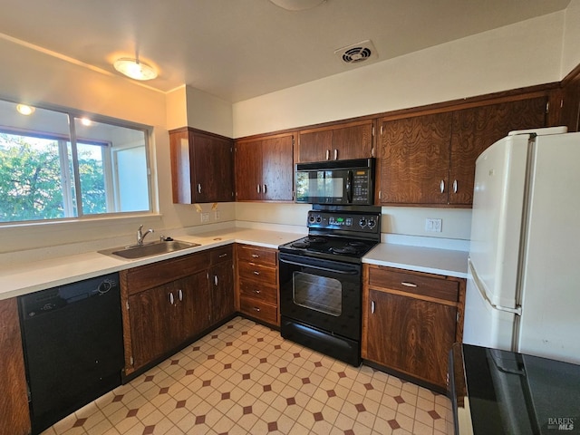 kitchen with dark brown cabinets, sink, and black appliances