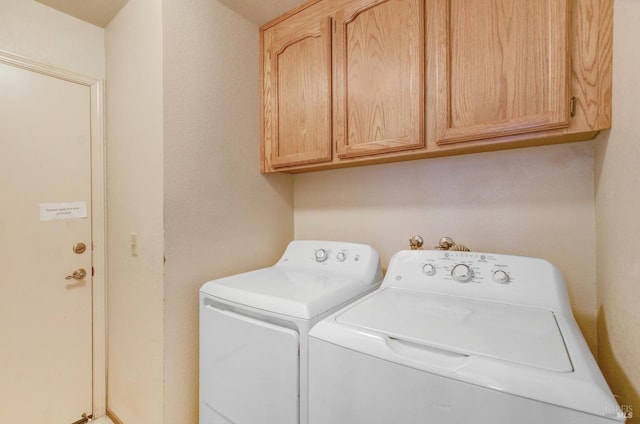 laundry room with cabinets and washer and clothes dryer