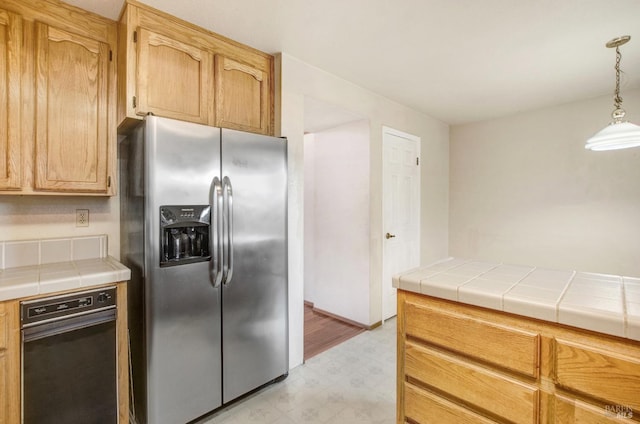 kitchen featuring tile countertops and stainless steel fridge