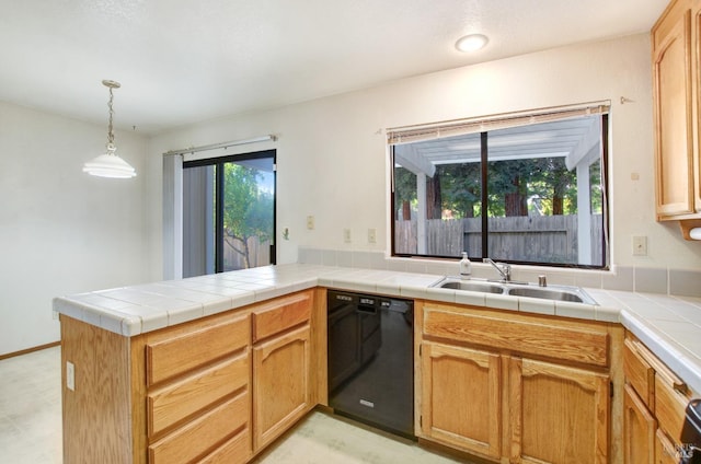 kitchen with tile countertops, sink, kitchen peninsula, and black dishwasher