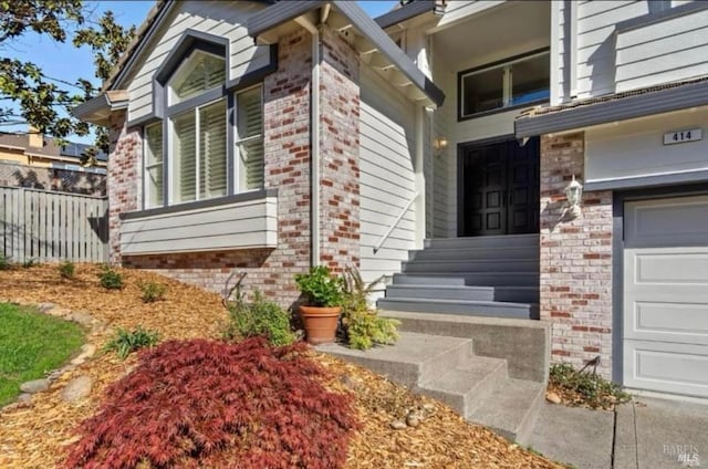 doorway to property with a garage