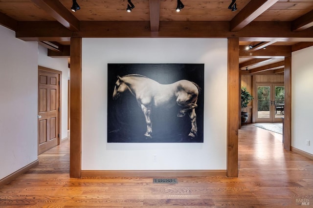 details featuring french doors, rail lighting, and hardwood / wood-style floors