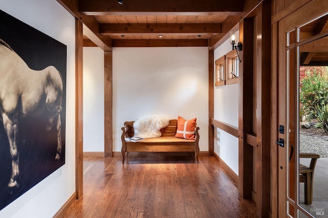 interior space with dark hardwood / wood-style floors, beam ceiling, and wooden ceiling