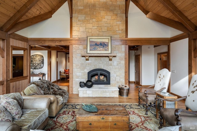 living room with beam ceiling, wood-type flooring, wooden ceiling, and high vaulted ceiling