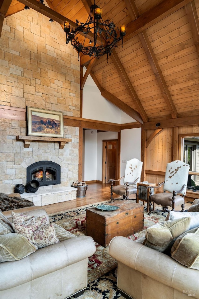 living room featuring beamed ceiling, a notable chandelier, wood-type flooring, and wooden ceiling