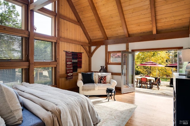 bedroom featuring beam ceiling, light hardwood / wood-style flooring, high vaulted ceiling, wood walls, and wood ceiling