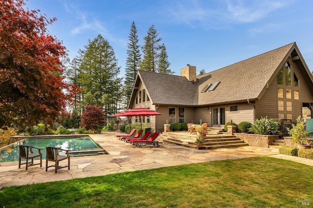 back of property featuring a lawn and a patio area