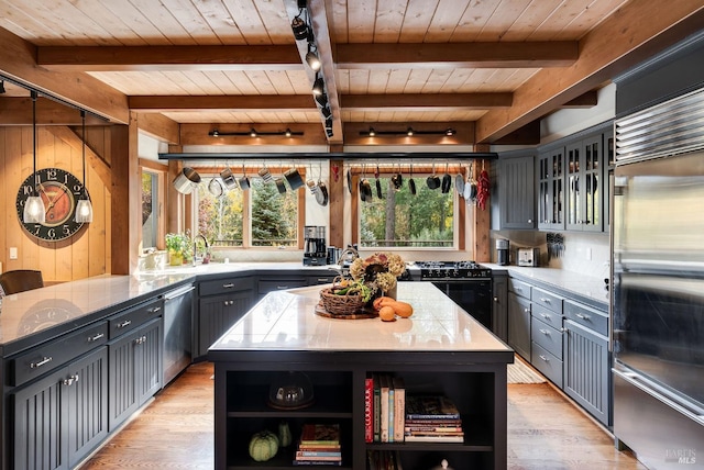 kitchen featuring stainless steel appliances, a kitchen island, and wooden ceiling