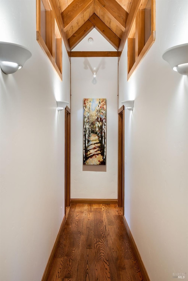 corridor featuring lofted ceiling with beams and dark wood-type flooring