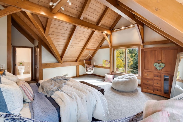 bedroom featuring lofted ceiling with beams, carpet floors, ensuite bath, and wood ceiling