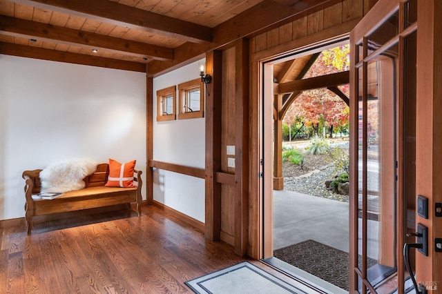 foyer featuring vaulted ceiling with beams, wooden ceiling, and dark wood-type flooring