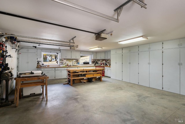 garage with a workshop area and a garage door opener