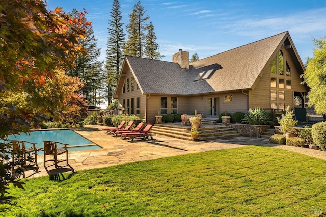 rear view of property with a lawn, french doors, and a patio