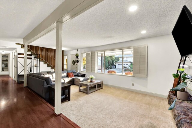 carpeted living room featuring a textured ceiling