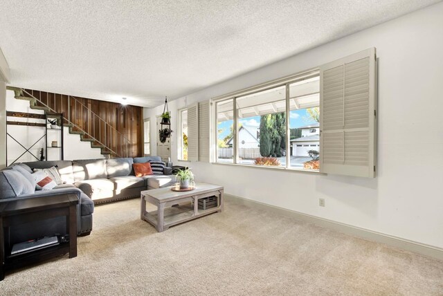 living room with light carpet and a textured ceiling