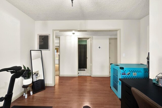 interior space with dark hardwood / wood-style flooring and a textured ceiling