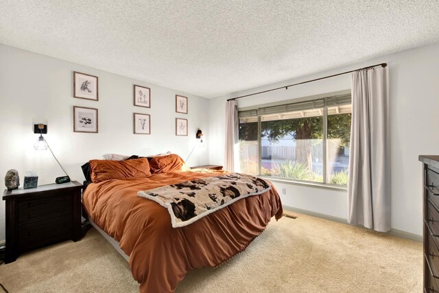 carpeted bedroom featuring a textured ceiling