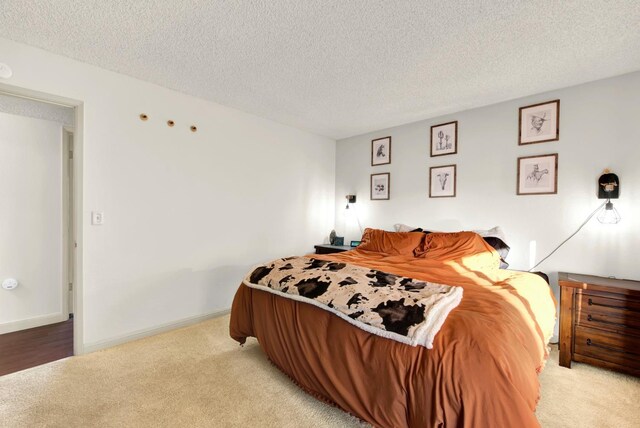 carpeted bedroom featuring a textured ceiling