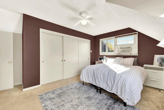 carpeted bedroom with cooling unit, a closet, and a textured ceiling