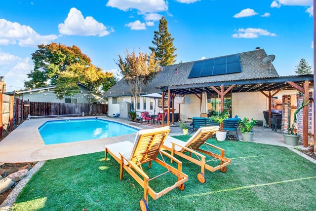 view of swimming pool featuring grilling area, a yard, and a patio area