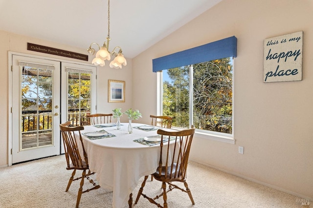 dining room featuring plenty of natural light, light colored carpet, and lofted ceiling