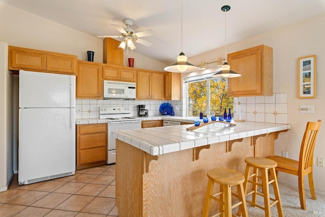 kitchen with tile counters, tasteful backsplash, kitchen peninsula, vaulted ceiling, and white appliances