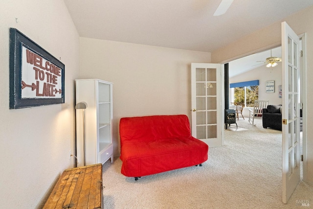 living area featuring ceiling fan, french doors, carpet floors, and vaulted ceiling