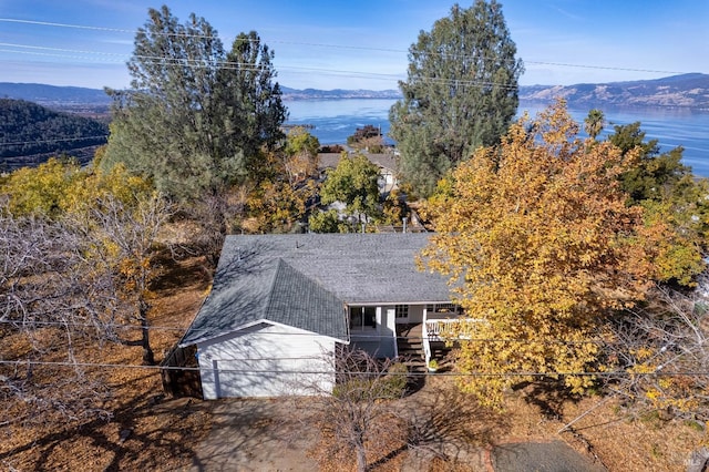 birds eye view of property with a water and mountain view