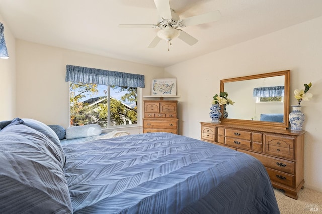 bedroom featuring light colored carpet and ceiling fan