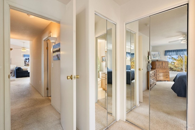 hallway with light colored carpet