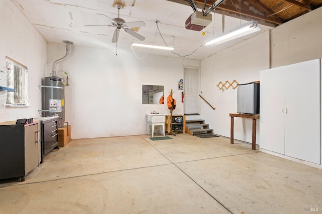 garage with strapped water heater, a garage door opener, and ceiling fan