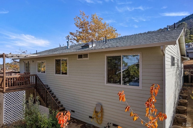 view of property exterior featuring a wooden deck