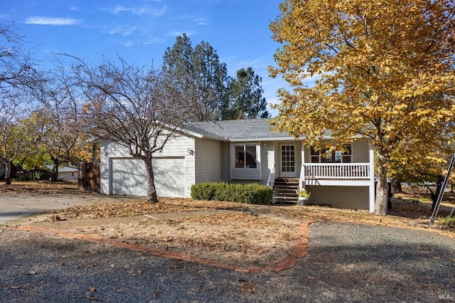 view of front of property with a porch and a garage