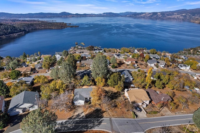 drone / aerial view featuring a water and mountain view