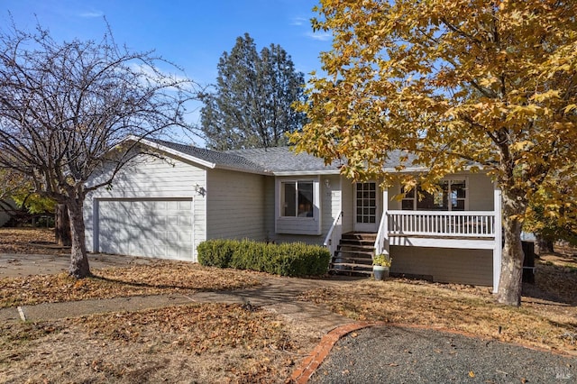 view of front of property with covered porch and a garage