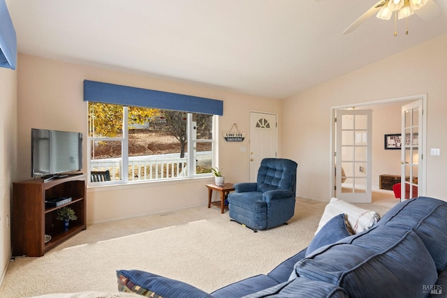 living room with carpet flooring, ceiling fan, vaulted ceiling, and french doors