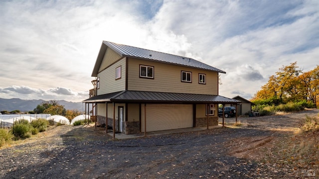 back of property with a mountain view