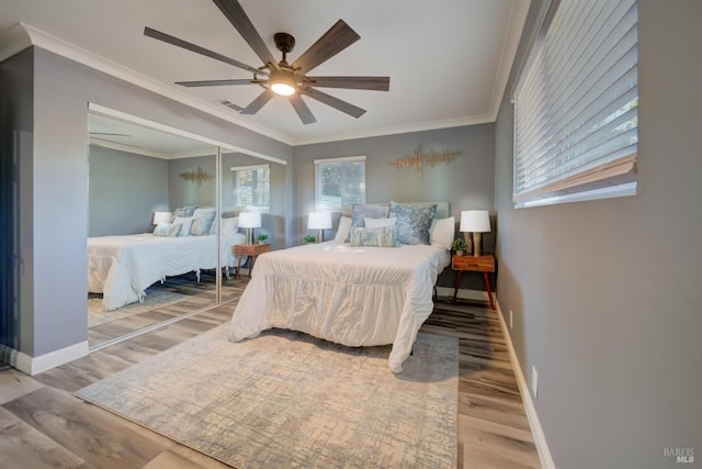 bedroom featuring ceiling fan, crown molding, and hardwood / wood-style flooring