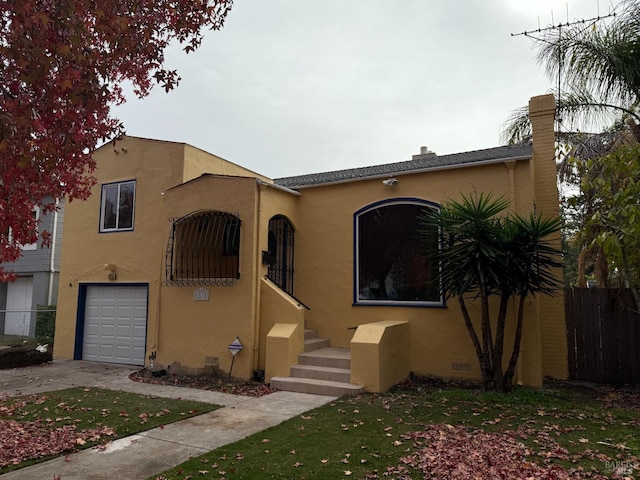 mediterranean / spanish-style house with a garage